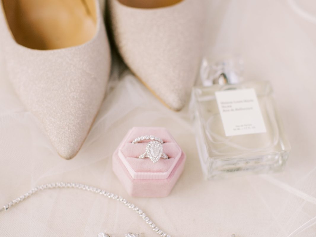 Flat lay of bridal jewelry on lace