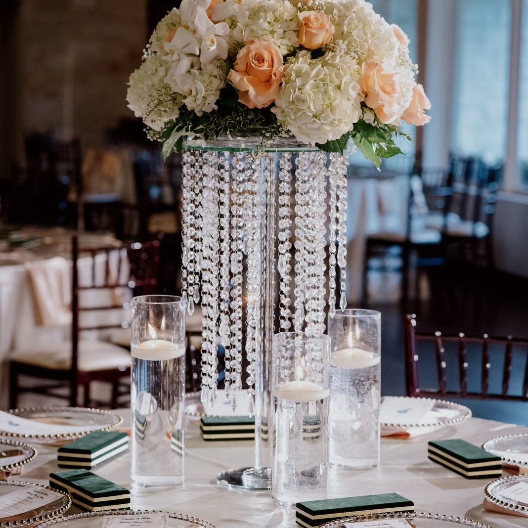 Wedding centerpiece arrangement in a tall trumpet vase